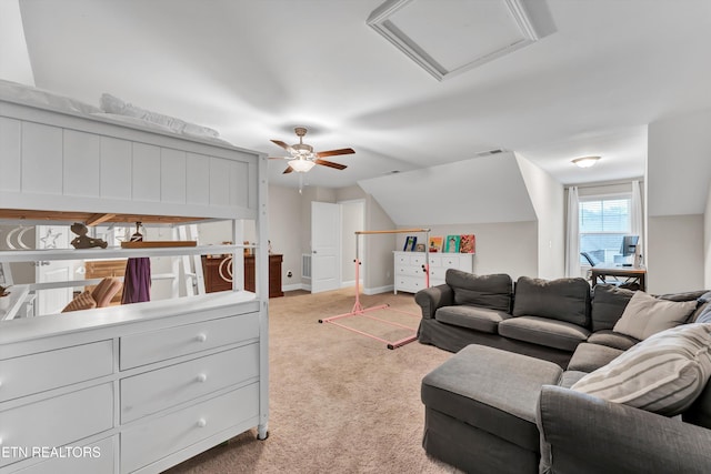 carpeted bedroom featuring attic access, ceiling fan, vaulted ceiling, and visible vents
