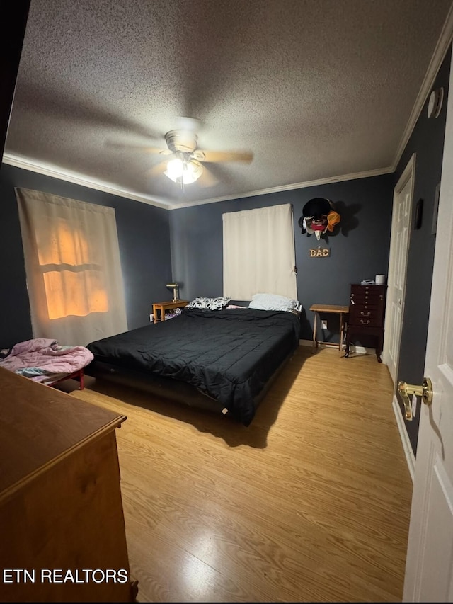 1211 Old Hollow Rd, Loudon, TN 37774 - bedroom with crown molding, wood finished floors, a textured ceiling, and a ceiling fan