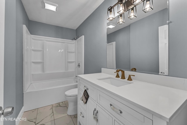 bathroom featuring vanity, marble finish floor, toilet, and tub / shower combination
