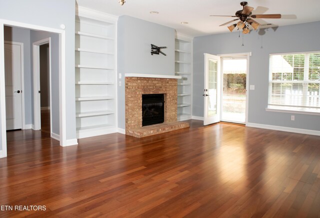 129 Mcneilly Cir, Maryville, TN 37803 - unfurnished living room featuring built in shelves, a ceiling fan, a brick fireplace, and wood finished floors