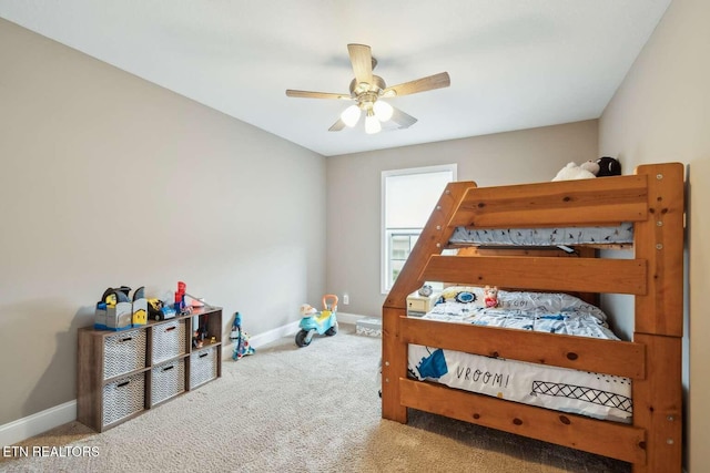 carpeted bedroom featuring ceiling fan and baseboards