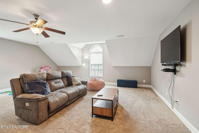 living area with ceiling fan, visible vents, carpet floors, lofted ceiling, and baseboards