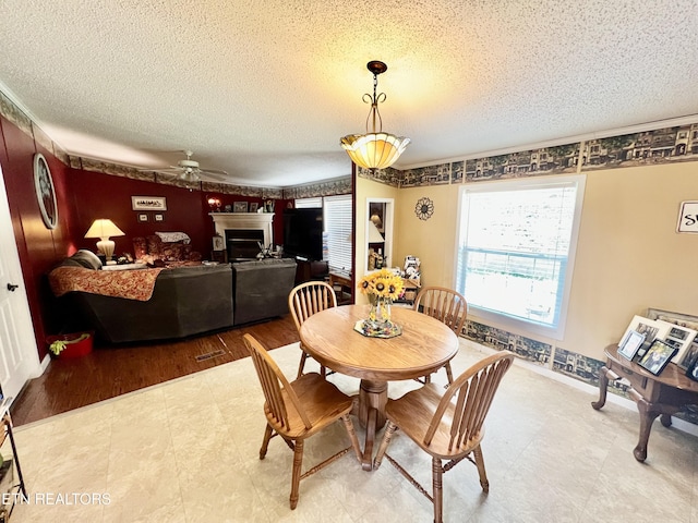 801 Lakeway Rd, Morristown, TN 37814 - dining space featuring ceiling fan, a textured ceiling, and a fireplace