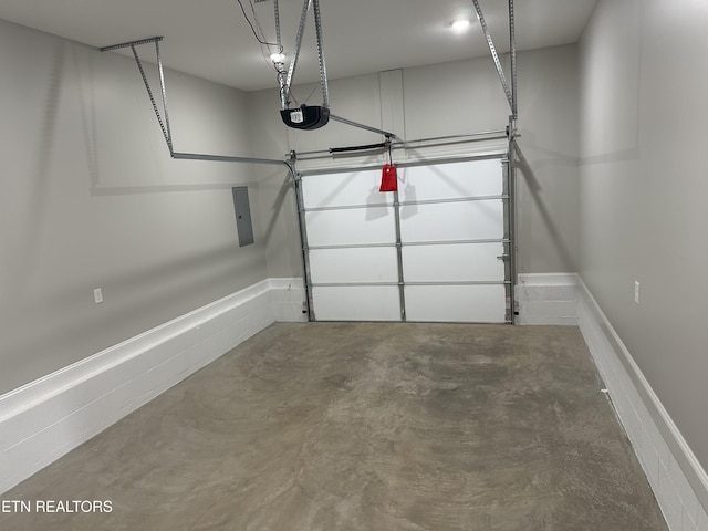 garage featuring a garage door opener and electric panel