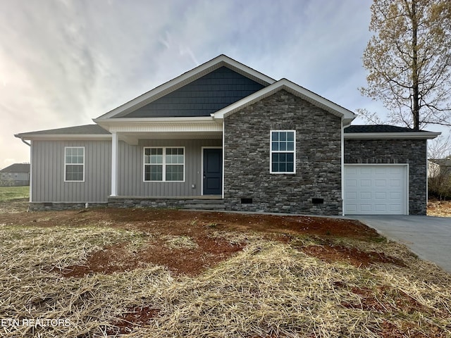 view of front facade with a porch, an attached garage, crawl space, board and batten siding, and driveway