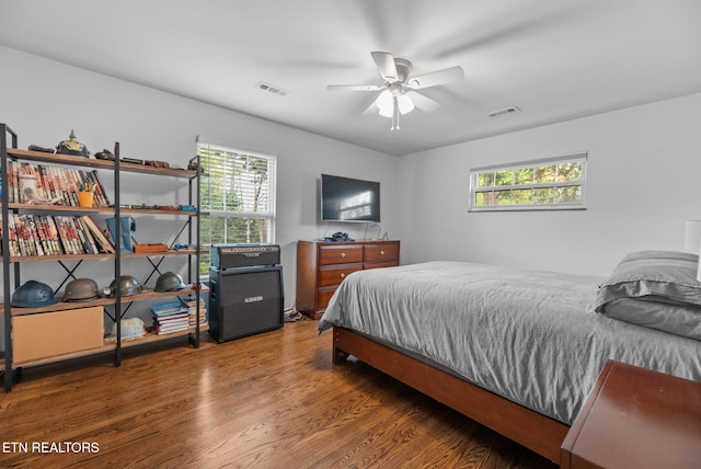 bedroom with visible vents, a ceiling fan, and wood finished floors