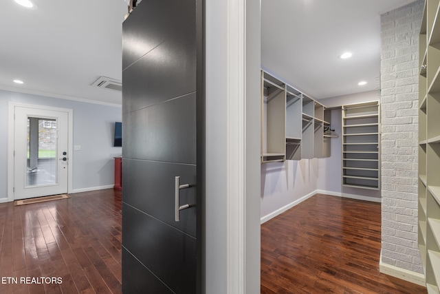 walk in closet with wood finished floors