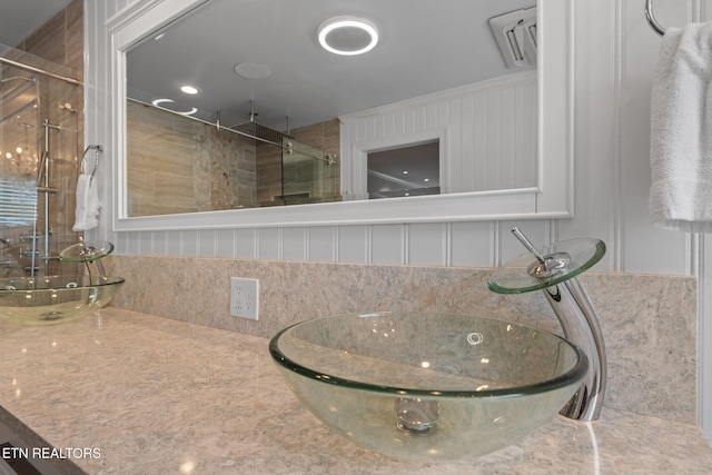 full bathroom with a stall shower and a sink