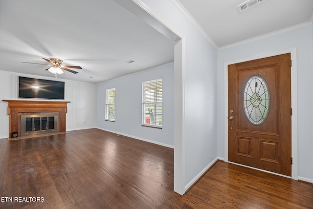 foyer featuring visible vents, dark wood-style flooring, crown molding, and ceiling fan