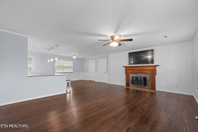 unfurnished living room with a fireplace with flush hearth, wood finished floors, ceiling fan, and visible vents