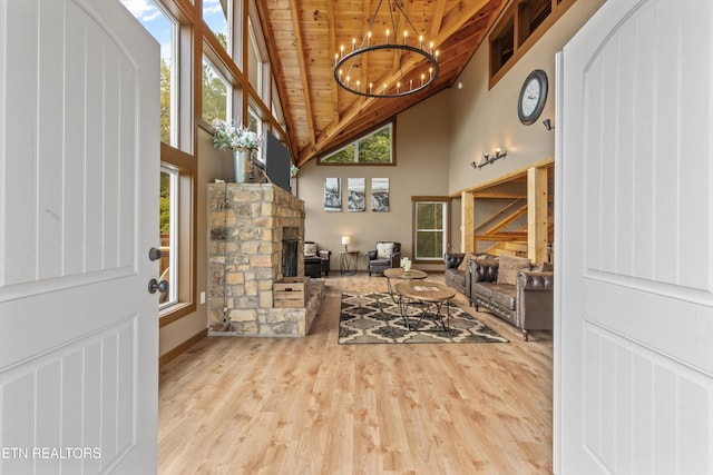 living room featuring a fireplace, wooden ceiling, an inviting chandelier, and wood finished floors