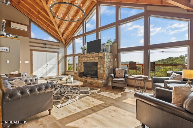 living room with a wealth of natural light, a wall mounted air conditioner, wood finished floors, and wood ceiling
