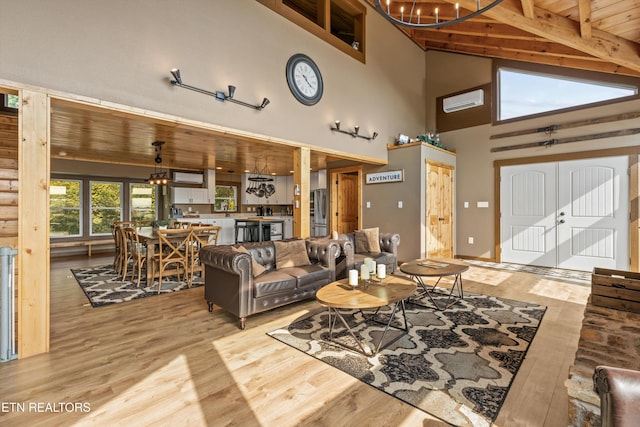 living area with wooden ceiling, light wood-style flooring, an AC wall unit, and an inviting chandelier