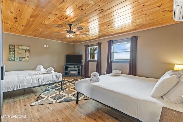bedroom with a wall mounted air conditioner, ceiling fan, wood ceiling, and wood finished floors