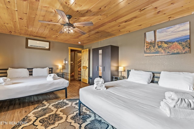 bedroom featuring wood ceiling, a ceiling fan, wood finished floors, and a wall unit AC