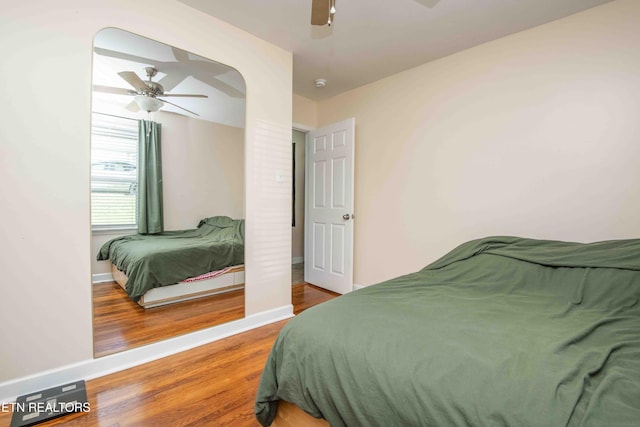 bedroom featuring baseboards, ceiling fan, and wood finished floors
