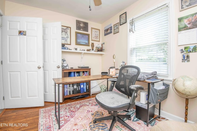 office area featuring ceiling fan, wood finished floors, and baseboards
