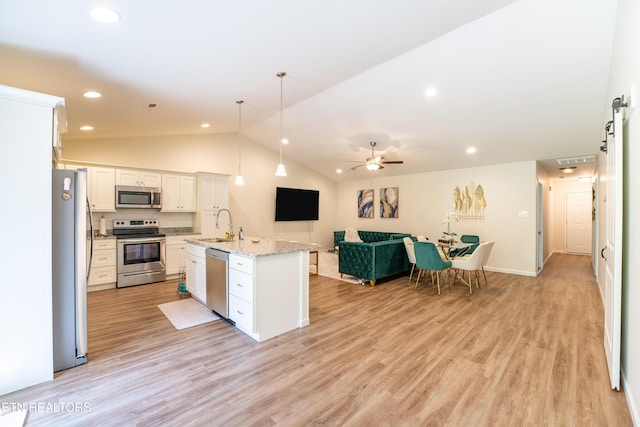 5925 Knox Hill Way, Knoxville, TN 37912 - kitchen with vaulted ceiling, open floor plan, stainless steel appliances, light wood finished floors, and white cabinetry