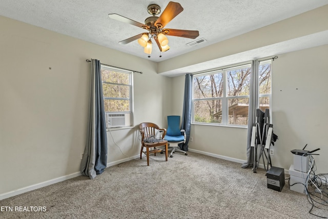 sitting room featuring a healthy amount of sunlight, carpet flooring, baseboards, and visible vents