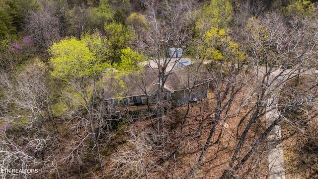 birds eye view of property with a forest view