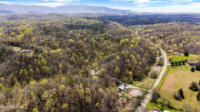 aerial view featuring a forest view and a mountain view
