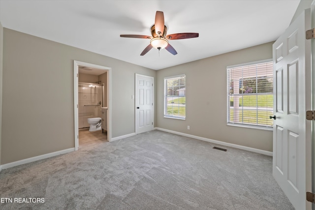 230 Briarcliff Ave, Oak Ridge, TN 37830 - unfurnished bedroom with ceiling fan, carpet, connected bathroom, visible vents, and baseboards
