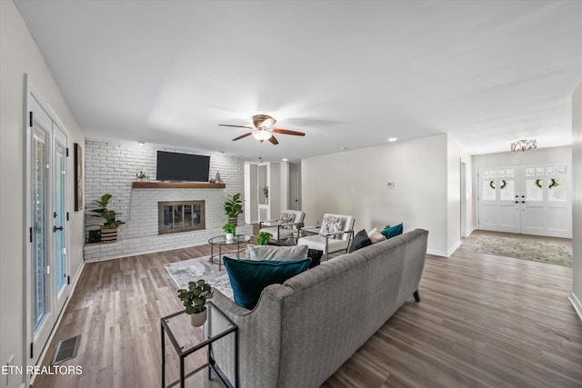 230 Briarcliff Ave, Oak Ridge, TN 37830 - living area with visible vents, wood finished floors, a brick fireplace, and a ceiling fan