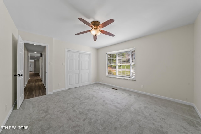 230 Briarcliff Ave, Oak Ridge, TN 37830 - unfurnished bedroom with a closet, baseboards, a ceiling fan, visible vents, and carpet