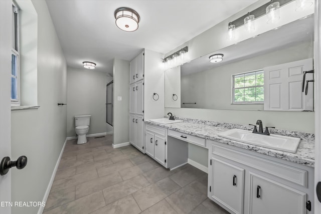 230 Briarcliff Ave, Oak Ridge, TN 37830 - bathroom featuring toilet, double vanity, a sink, and walk in shower
