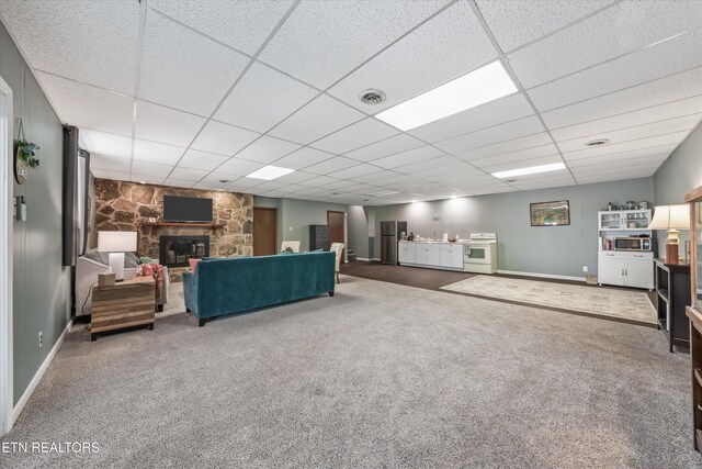 230 Briarcliff Ave, Oak Ridge, TN 37830 - living area featuring carpet, a stone fireplace, a drop ceiling, and visible vents