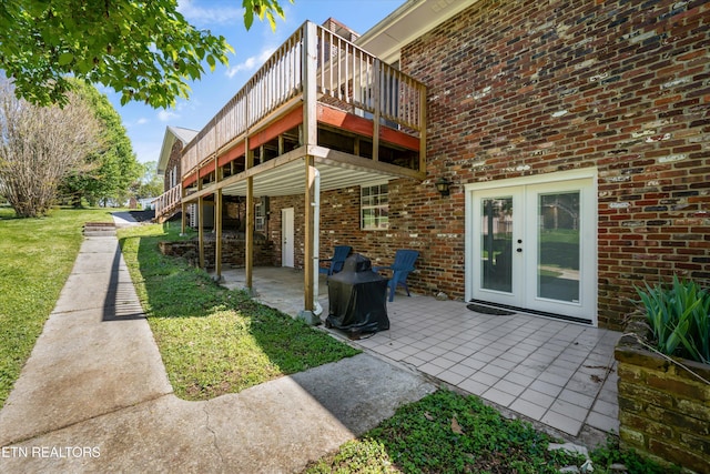 230 Briarcliff Ave, Oak Ridge, TN 37830 - back of house featuring a lawn, a patio area, and brick siding