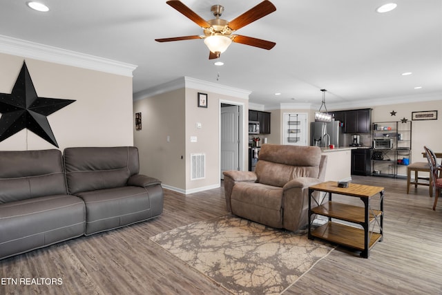 5811 Rain Cloud Rd, Knoxville, TN 37918 - living area with recessed lighting, light wood-style floors, a ceiling fan, and ornamental molding
