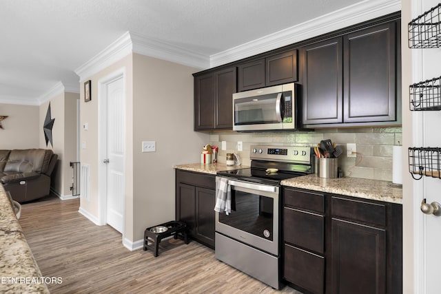 5811 Rain Cloud Rd, Knoxville, TN 37918 - kitchen featuring stainless steel appliances, ornamental molding, light wood-type flooring, tasteful backsplash, and dark brown cabinetry