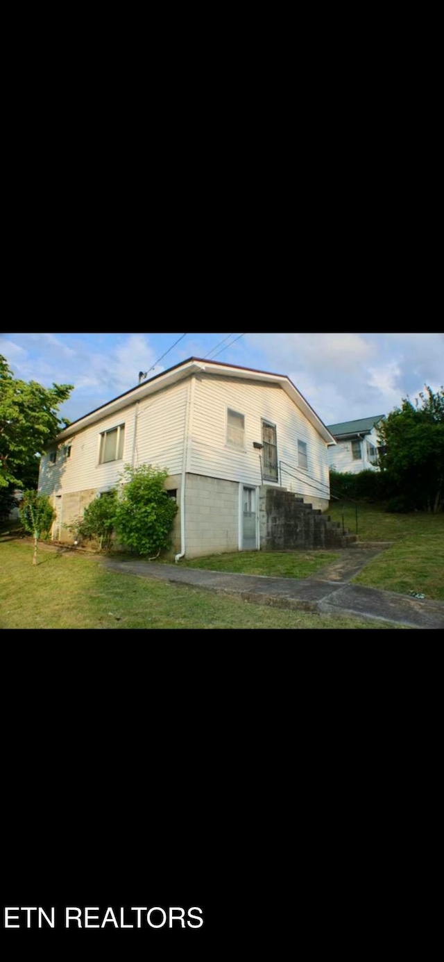 view of home's exterior featuring a yard