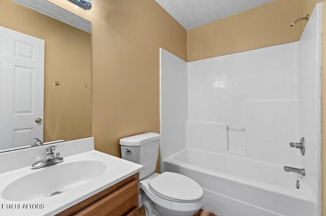 full bathroom with vanity, toilet, and  shower combination
