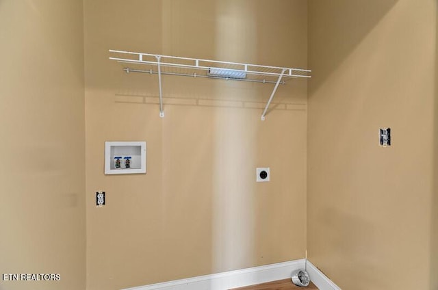 clothes washing area with hookup for an electric dryer, washer hookup, baseboards, and laundry area