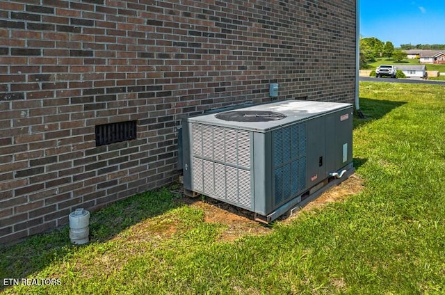 exterior details with brick siding and central AC