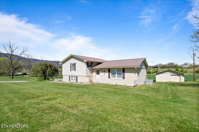 split level home with brick siding, a front lawn, and metal roof