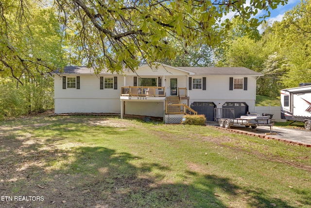 9204 Chamaeleon Trl, Harrison, TN 37341 - view of front of house featuring a garage, driveway, a front lawn, and stairway