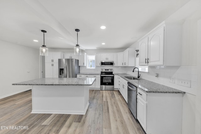 9204 Chamaeleon Trl, Harrison, TN 37341 - kitchen with a sink, white cabinetry, light stone countertops, and stainless steel appliances
