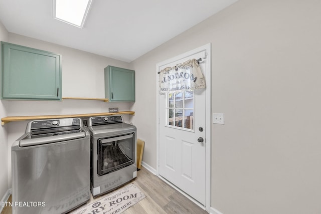 9204 Chamaeleon Trl, Harrison, TN 37341 - laundry room featuring light wood finished floors, washing machine and dryer, baseboards, and cabinet space