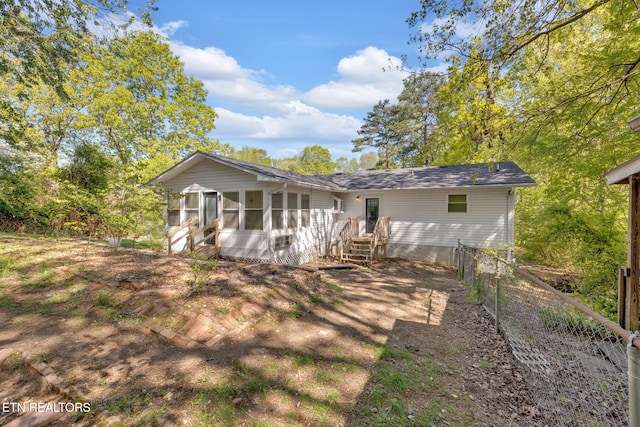 9204 Chamaeleon Trl, Harrison, TN 37341 - rear view of house with roof with shingles, a sunroom, and fence
