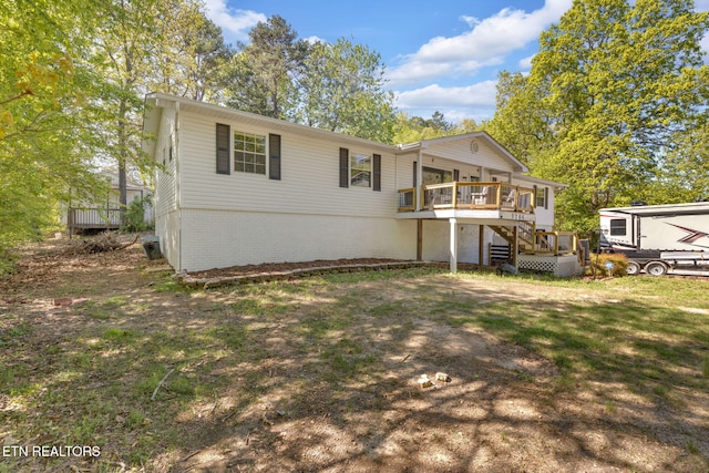 9204 Chamaeleon Trl, Harrison, TN 37341 - back of house with stairs, a deck, and a yard