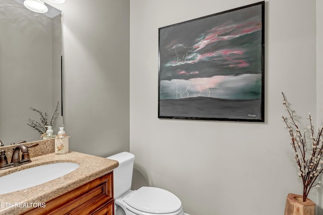 bathroom with toilet and vanity