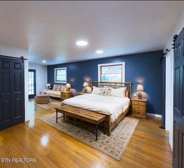 355 E Chestnut Hill Rd, Townsend, TN 37882 - bedroom with a barn door, wood finished floors, recessed lighting, and baseboards