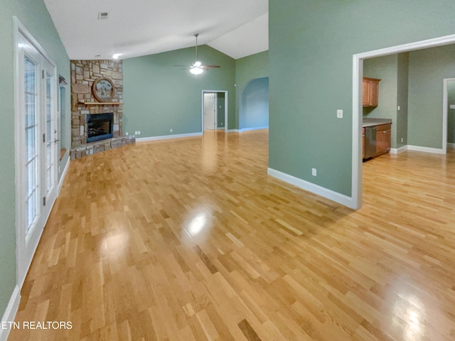 1056 Willow Creek Cir, Maryville, TN 37804 - unfurnished living room featuring baseboards, ceiling fan, light wood-type flooring, a fireplace, and vaulted ceiling