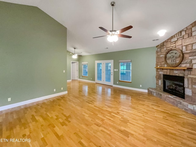 1056 Willow Creek Cir, Maryville, TN 37804 - unfurnished living room with visible vents, a stone fireplace, a ceiling fan, and wood finished floors