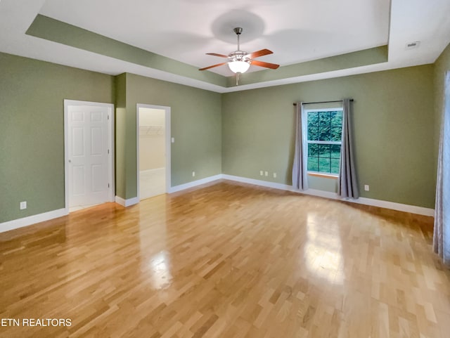 1056 Willow Creek Cir, Maryville, TN 37804 - spare room with a tray ceiling, baseboards, light wood finished floors, and a ceiling fan