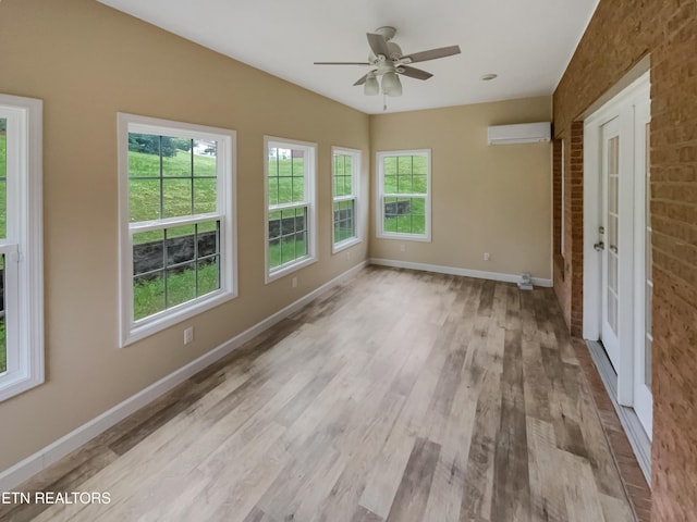 1056 Willow Creek Cir, Maryville, TN 37804 - unfurnished room with baseboards, a ceiling fan, wood finished floors, and a wall mounted air conditioner