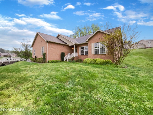 1056 Willow Creek Cir, Maryville, TN 37804 - exterior space featuring a shingled roof, brick siding, and a front lawn